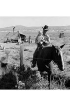 Cowboy holds his baby while riding a horse by Dorothea Lange - Art Print - £17.37 GBP+