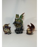 Lot Of Three Dragon Figurines, one on skull, one in egg and one chained - $40.00