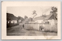 RPPC Three Boys Stand Along Fence In Village c1910 Real Photo Postcard B47 - £6.35 GBP