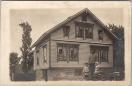 RPPC Family Posing with House Peeking Out Windows c1915 Photo Postcard A30 - £11.95 GBP