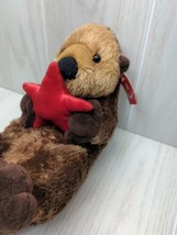 Aurora Plush sea river otter on back holding red starfish Unused with tags 2022 - £11.62 GBP