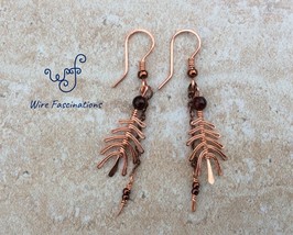 Handmade copper feather earrings with garnet and fine chain dangles - $515.29 MXN