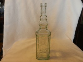 Vintage Clear Glass Bottle With Embossed Designs 11.75&quot; Tall - £39.33 GBP