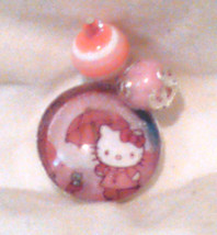 1" Pink Hello Kitty with an umbrella Pendant with glass insert and 2 dangle bead - $6.00