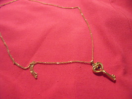 Avon Key Pendant with Red Faux Ruby Stone on 18" Chain - $27.00
