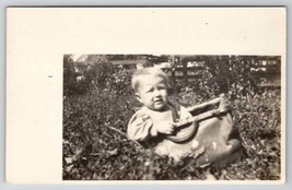 RPPC Adorable Blonde Hair Baby in Bag on Grass c1910 Postcard F23 - £5.46 GBP