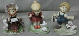 Brinn&#39;s 3 Ceramic Figurines Boy Girl Playing w/ Dogs Girl Playing Accordian  - £19.97 GBP