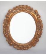 Espejo oval dorado y tallado en madera. - $4,352.57 MXN