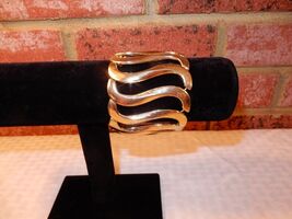 Vintage gold tone metal elasticized cuff bracelet with swirl pattern - $12.00