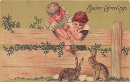 Easter Greeting~Young Boy &amp; Girl Watch Rabbits &amp; Eggs Over Fence Postcard c1918 - £3.70 GBP