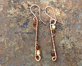 Handmade copper earrings: long scroll wire wrapped with amber glass beads - £19.66 GBP