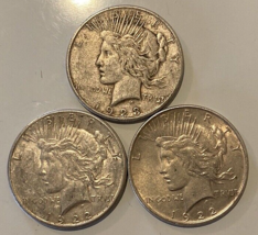 Lot of Three Peace Silver Dollars. - $96.67