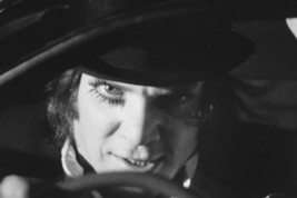 A Clockwork Orange Malcolm Mcdowell menacing behind car wheel 18x24 Poster - $23.99