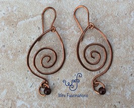 Handmade copper earrings: Large teardrop spiral with garnet bead - $20.00