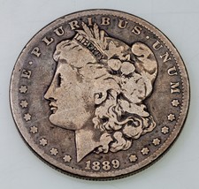 1889-CC $1 Silver Morgan Dollar in Good Condition, Full Rims, Natural Color - £696.21 GBP