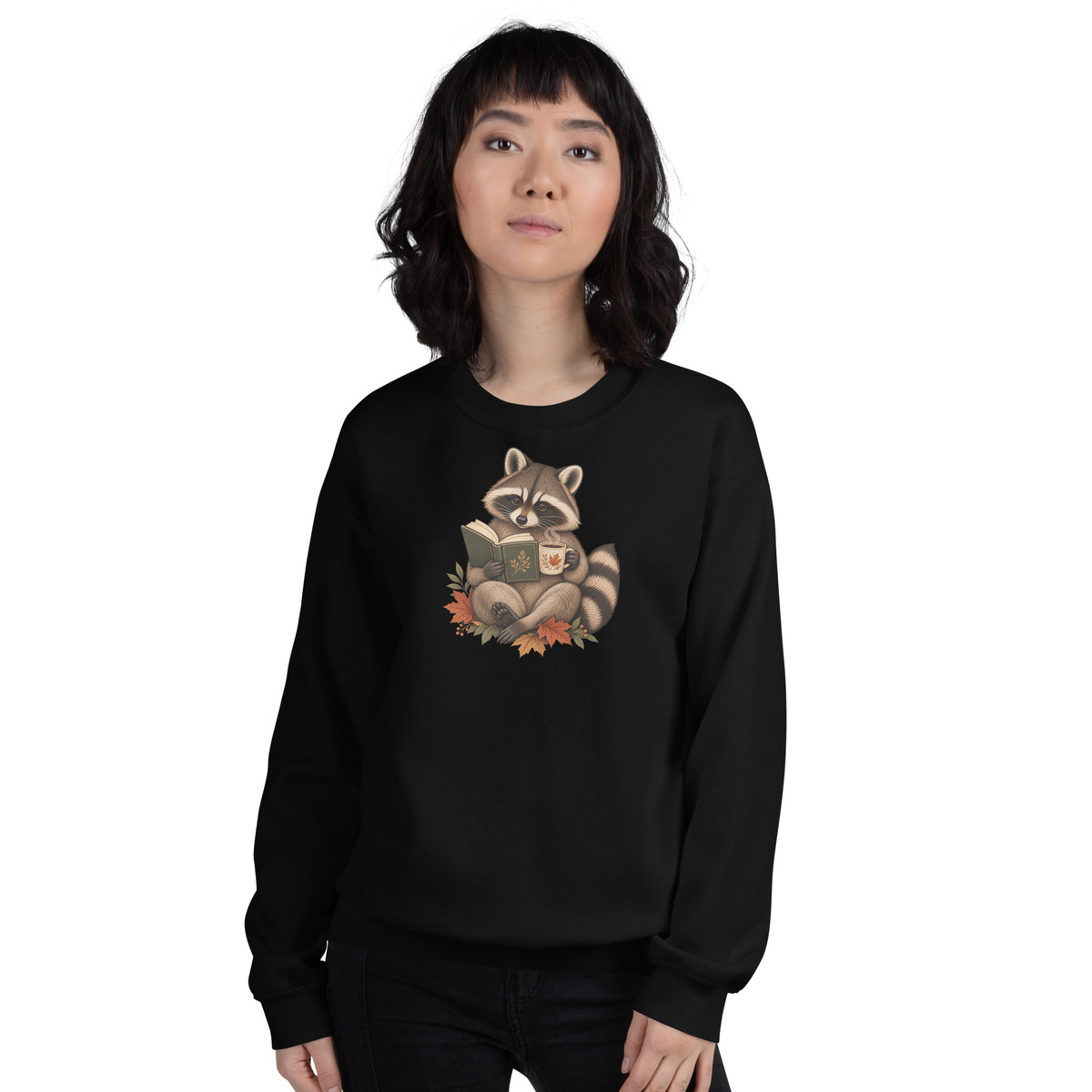 Printful digital mockup of the same black Reading Raccoon crewneck sweatshirt on a female model, viewed from the front.
