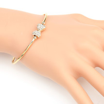 Gold Tone Bangle Bracelet With Sparkling Crystal Bow - $27.99