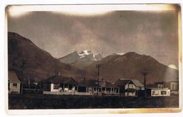 Landscape Postcard RPPC Storm Coming Homes Nestled In Mountains - $7.91