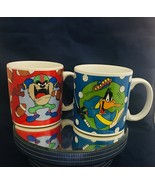 Looney Tunes 2 mugs Daffy Duck Golf &amp; Tasmanian Devil Football 1994 Warn... - $14.84