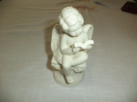 White Opalescent Angel Figurine Holding Bible - $228.43 MXN