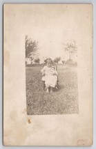 RPPC Cutest Little Girl Seated with her China Head Doll in Yard Postcard... - $19.95