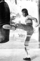 Patrick Swayze bare chested kicks punchbag cool pose Roadhouse 18x24 Poster - $23.99