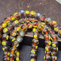 Brown tint small yellow smiley faces Venetian inspired Beads Strand - $874.31 MXN