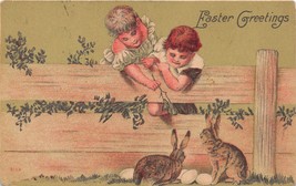 Easter Greeting~Young Boy &amp; Girl Watch Rabbits &amp; Eggs Over Fence Postcard c1918 - £3.82 GBP