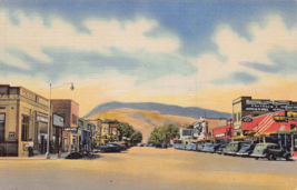 Cody Wyoming~Main STREET-STOREFRONTS-40s Cars~Rattlesnake Mountain Postcard - £4.95 GBP