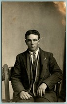 RPPC Studio View Named Subject Guy Cox  Handsome Man in Chair H5 - £11.78 GBP