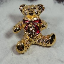 1989 Avon Textured Gold Tone Teddy Bear with a Bright Red Enamel Ribbon Bow - $11.88