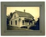 Man &amp; Woman Sitting in Front of Family Home Photograph on Backer Board - $14.82