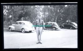 black and white negative - man standing in front of parked cars - $8.50