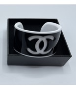 CHANEL BLACK  OUTSIDE & WHITE INSIDE  CC RESIN SPORTY CUFF BRACELET - $203.36 CAD CHANEL BLACK  OUTSIDE & WHITE INSIDE  CC RESIN SPORTY CUFF BRACELET - $203.36 CAD