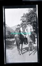 black and white negative - man and woman on horseback * trees in background - $8.95
