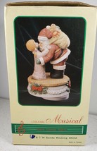 Ceramic Musical 6 1/2&quot; Tall Santa Kissing Child Playing Here Comes Santa Clause - £20.40 GBP