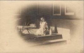 RPPC Little Girl Pretty Hair Bow Baby Quart of Milk on Porch Postcard U6 - £5.22 GBP