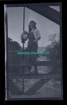 black and white negative - young woman standing on fence rail with hat i... - $8.95