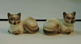 Vintage SALT AND PEPPER SHAKERS Porcelain Siamese Cats Laying Down - $19.75