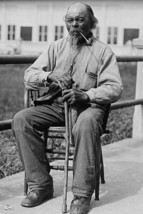 Portrait of an Male Ex-Slave Sitting in Chair &amp; Smoking 20 x 30 Poster - $25.98