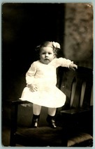 RPPC Adorable Little Girl In White Dress Standing on Chair Studio View H5 - $3.91