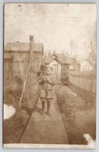 RPPC Adorable Little Boy on Plank Sidewalk Old Shed Barns c1908 Postcard G24 - £7.95 GBP