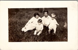 RPPC Sweet Family Sitting on Lawn Two Darling Children Postcard E22 - £6.34 GBP