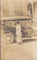 RPPC woman with big hat in front of antique automobile - £11.20 GBP