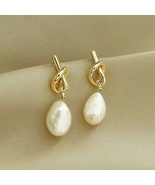 Pearl earrings with yellow gold tone knot design for women 30mm high - $45.00