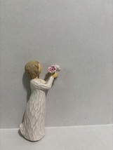 Girl Holing Out Flower - $285.54 MXN