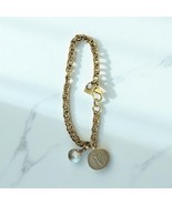 John Wind Gold Tone “V” monogram bracelet - $281.01 MXN