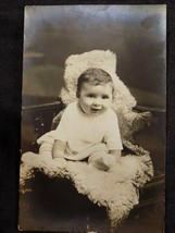 Antique PHOTO CORRESPONDENCE POSTCARD Smiling Baby on Lambskin - $1.97