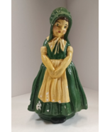 Vintage chalkware little girl in dark green dress and yellowish apron. - $132.49 MXN