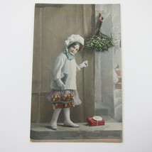 Christmas Postcard Victorian Girl White Sweater Hat Wrapped Gift Package Antique - £7.82 GBP